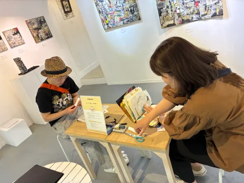 Participants choosing a fragment of artwork to encapsulate their feelings into a single card